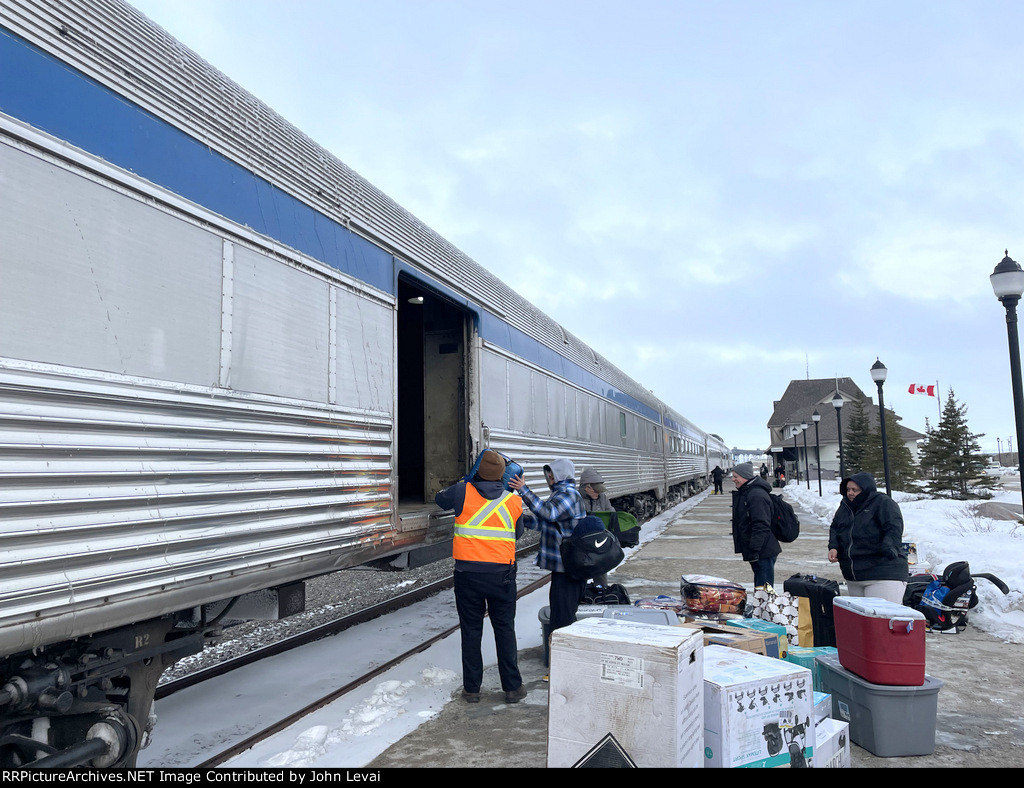 A lot of luggage getting unloaded from the baggage car 